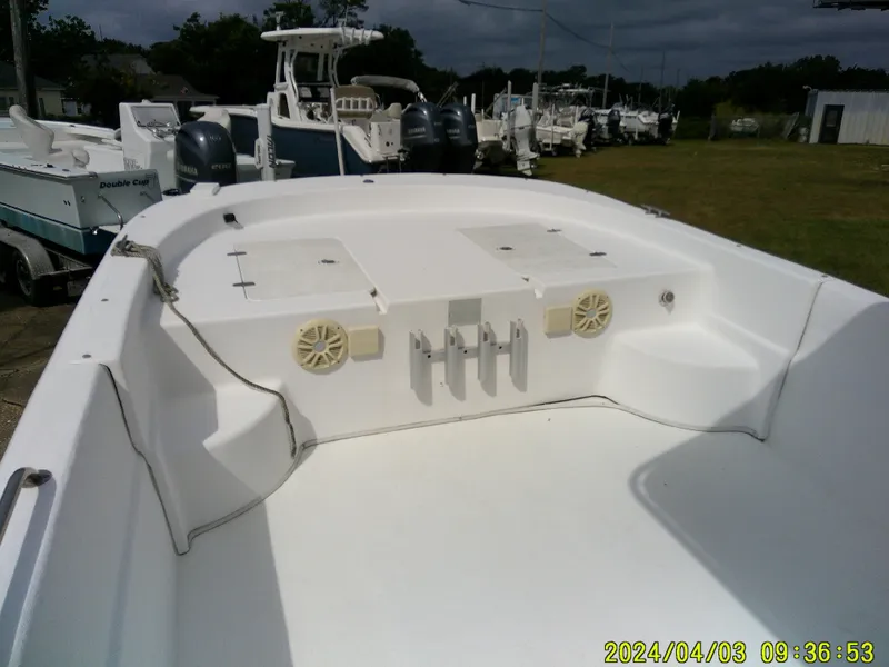Slide: The Image of 2010 Carolina Skiff 238 DLV boat interior with storage compartments and speakers. - 13