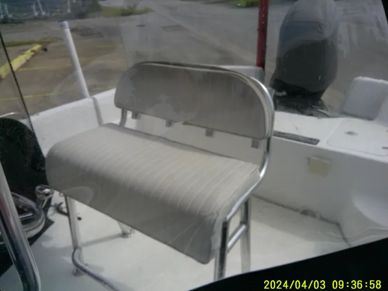 Slide: The Image of 2010 Carolina Skiff 238 DLV boat interior with seating and motor, dated April 3, 2024. - 14