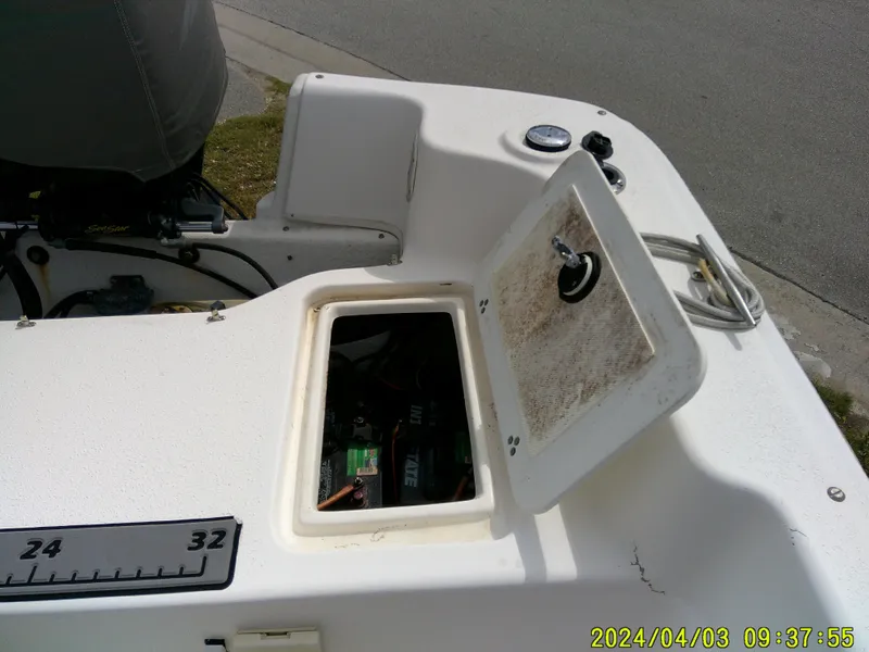Slide: The Image of Open hatch on a 2010 Carolina Skiff 238 DLV boat, showing internal components. - 17
