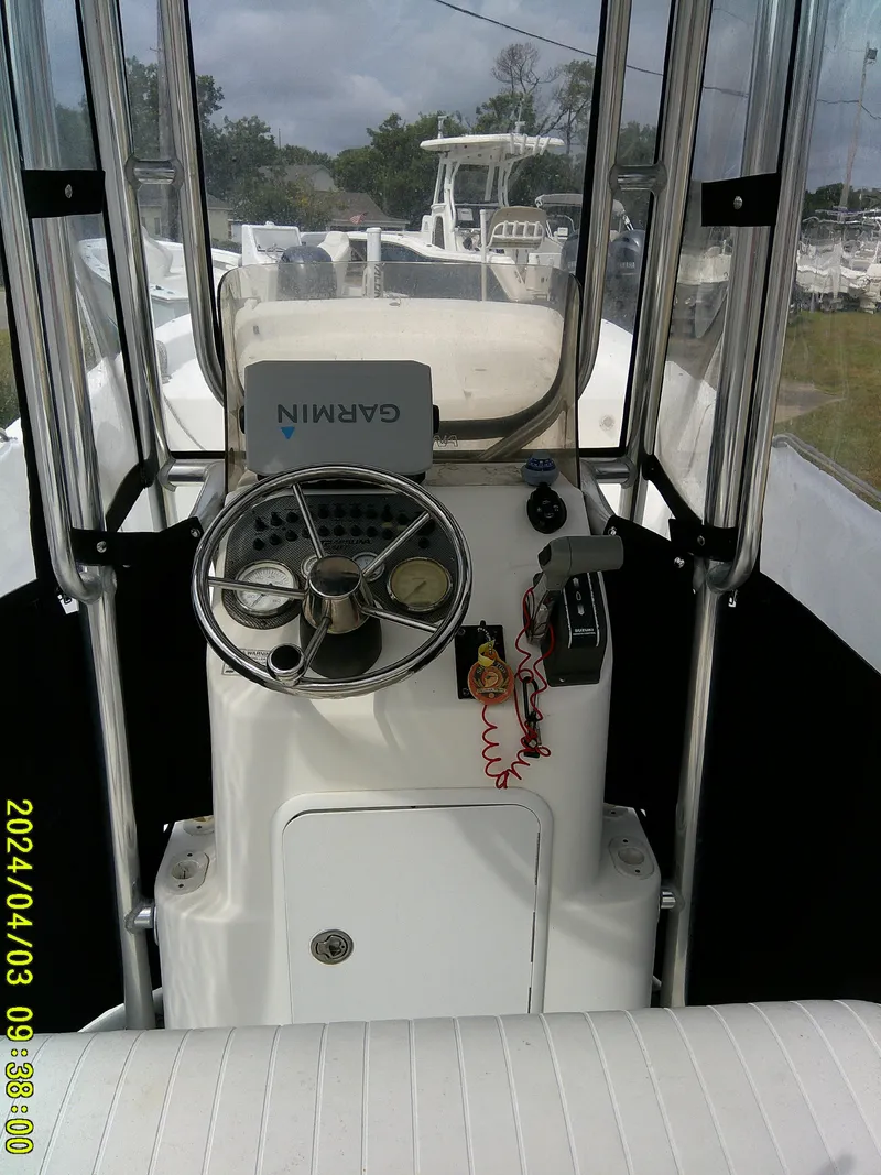 Slide: The Image of 2010 Carolina Skiff 238 DLV boat console with Garmin GPS and steering wheel. - 18