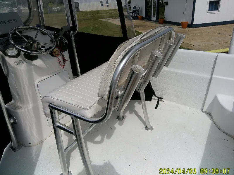 Slide: The Image of Interior of a 2010 Carolina Skiff 238 DLV boat with steering wheel and seating. - 19