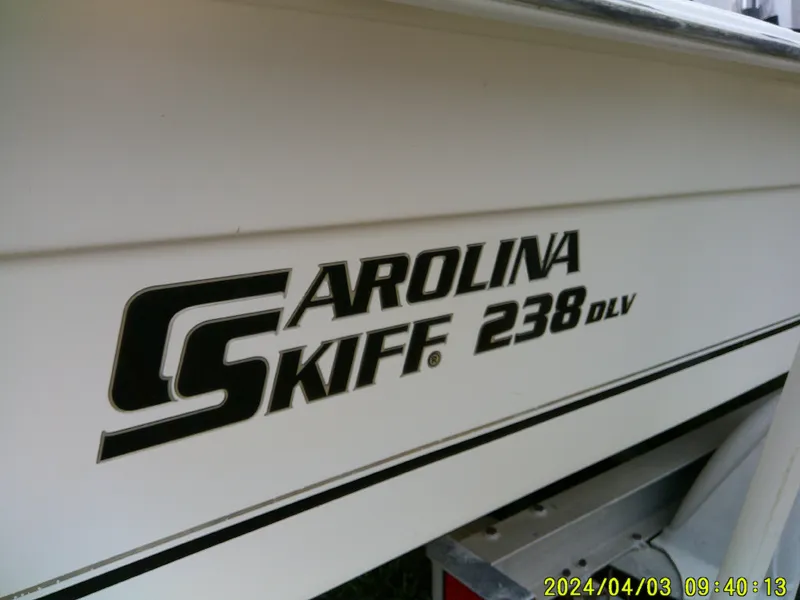 Slide: The Image of 2010 Carolina Skiff 238 DLV boat side view with logo and date stamp. - 24