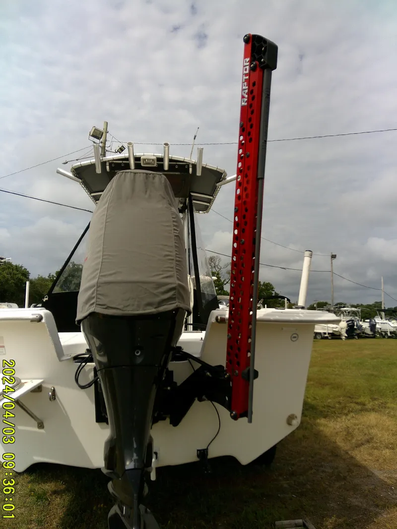 Slide: The Image of 2010 Carolina Skiff 238 DLV boat with covered outboard motor and red power pole. - 7