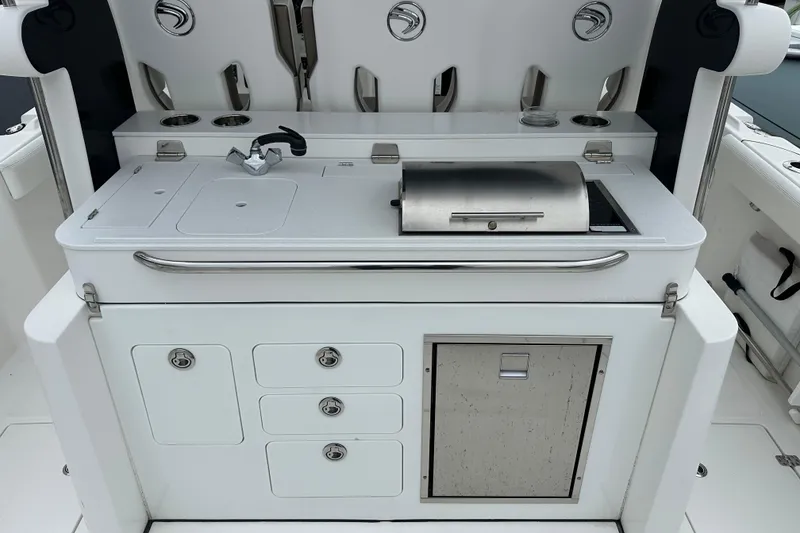 Slide: The Image of Outdoor kitchen setup on a 2020 Edgewater 370CC boat, featuring a grill and sink. - 11