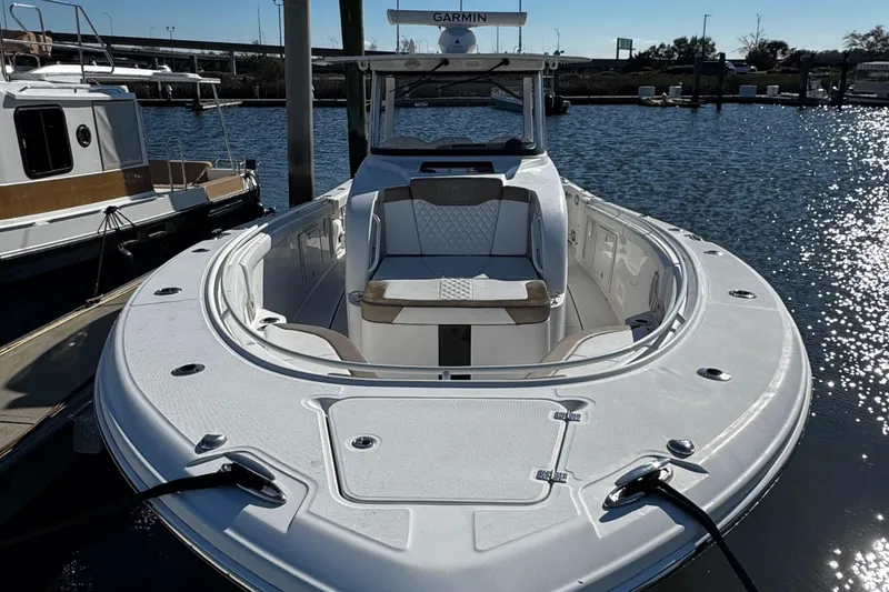 Slide: The Image of 2020 Edgewater 370CC boat docked in marina, featuring spacious seating and sleek design. - 12