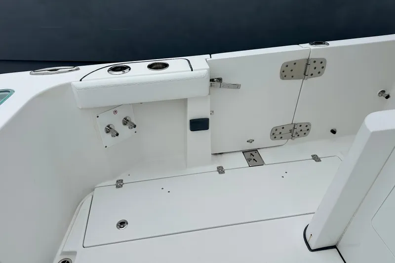 Slide: The Image of 2020 Edgewater 370CC boat interior with white seating and stainless steel fixtures. - 14