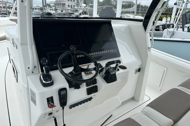 Slide: The Image of 2020 Edgewater 370CC boat helm with modern controls and navigation screens. - 2
