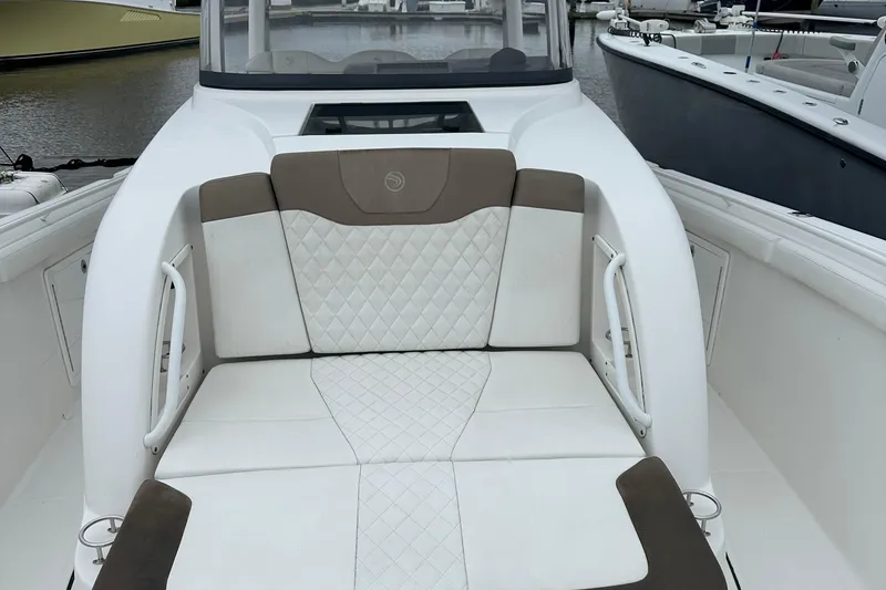 Slide: The Image of 2020 Edgewater 370CC boat interior with cushioned seating and elegant design. - 7