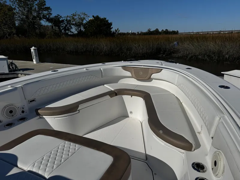 Slide: The Image of 2020 Edgewater 370CC boat interior with cushioned seating and sleek design. - 9