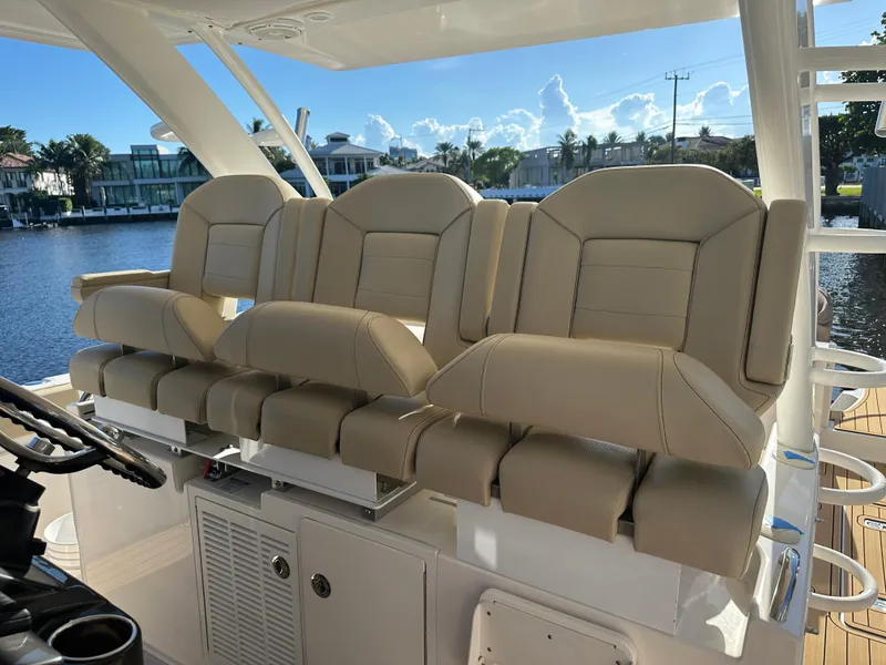 Slide: The Image of Luxurious seating on a 2018 Pursuit 408S boat, overlooking a scenic waterfront. - 11