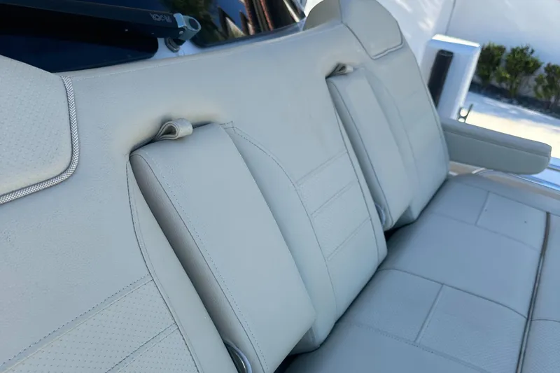 Slide: The Image of 2018 Pursuit 408S boat interior with beige leather seating. - 16