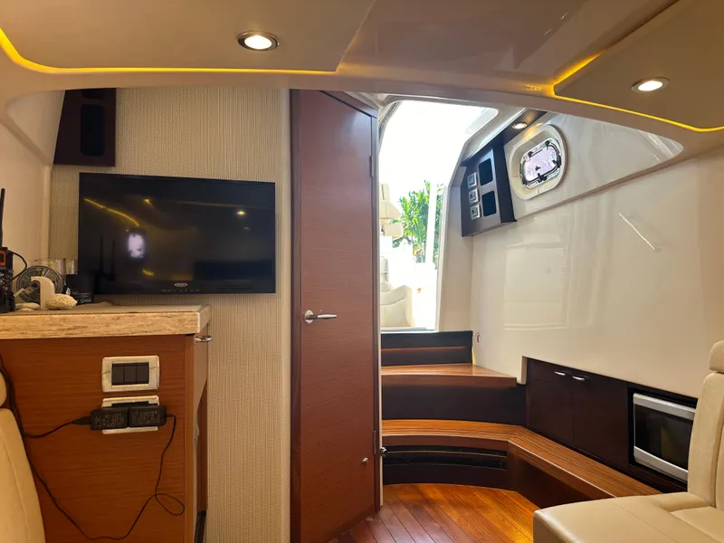 Slide: The Image of Luxurious interior of 2018 Pursuit 408S boat with modern amenities and wooden accents. - 19