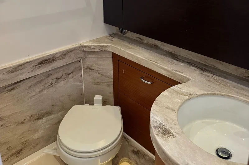 Slide: The Image of Luxurious 2018 Pursuit 408S yacht bathroom with marble countertop and modern fixtures. - 23