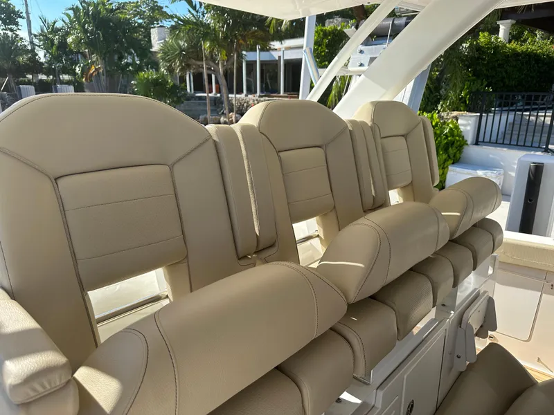 Slide: The Image of Luxurious seating on 2018 Pursuit 408S boat, featuring beige leather upholstery. - 3