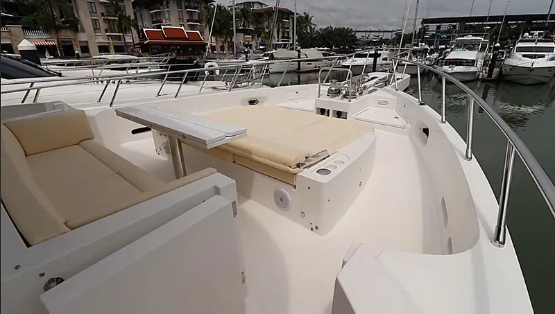 Slide: The Image of Luxurious 2027 Selene 64 yacht deck with seating and table, docked at marina. - 10