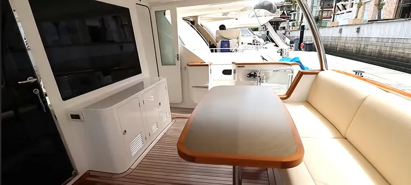 Slide: The Image of Luxurious Selene 64 yacht interior, featuring elegant seating and a polished wooden table, 2027 model. - 14