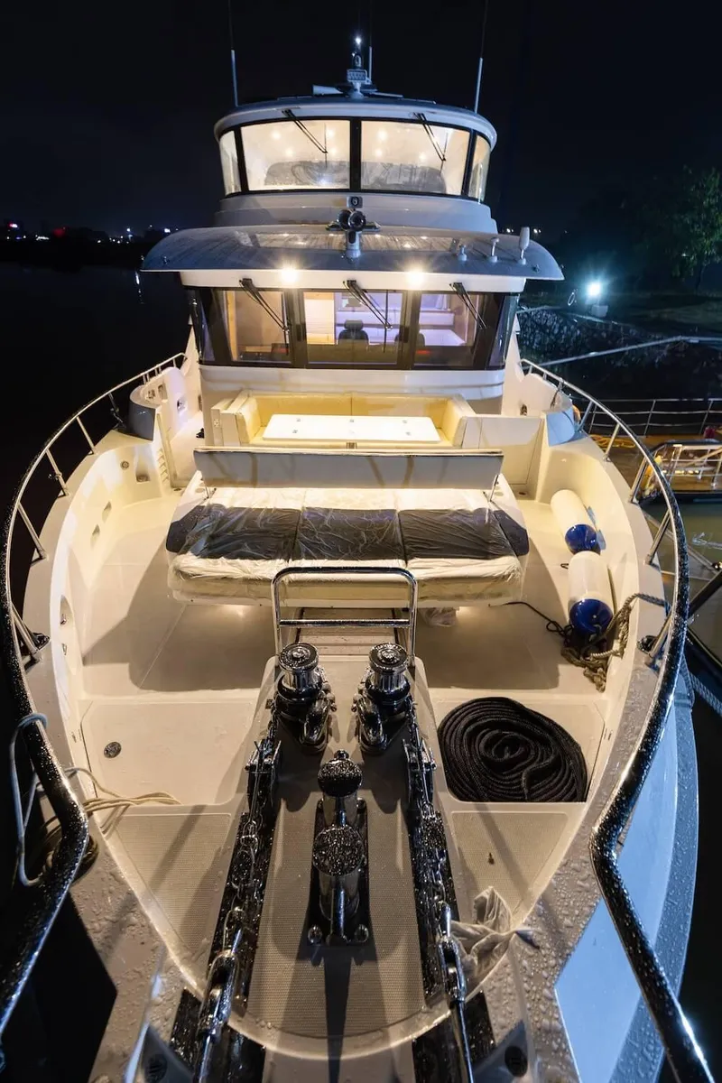 Slide: The Image of Luxurious Selene 64 yacht, 2027 model, illuminated deck at night, showcasing modern design and amenities. - 17