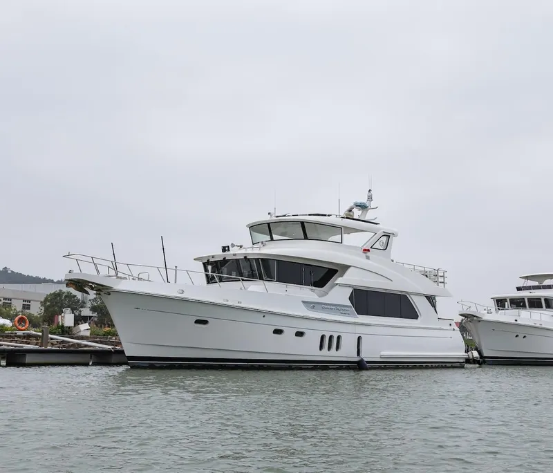 Slide: The Image of Selene 64 Ocean Explorer 2027 yacht docked in a marina, overcast sky. - 19