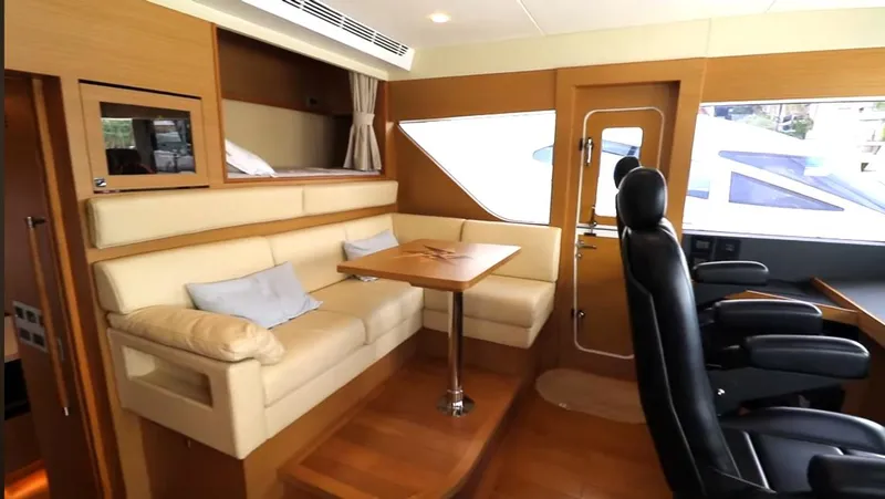 Slide: The Image of Interior of 2027 Selene 64 yacht with seating, table, and helm chairs. - 3
