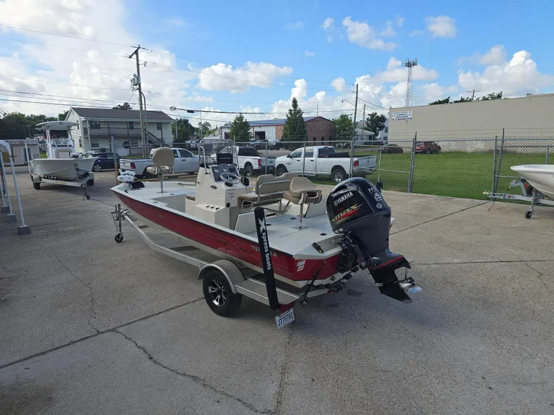 Slide: The Image of 2020 Xpress H20B boat with Yamaha outboard motor on a trailer in a parking lot. - 10