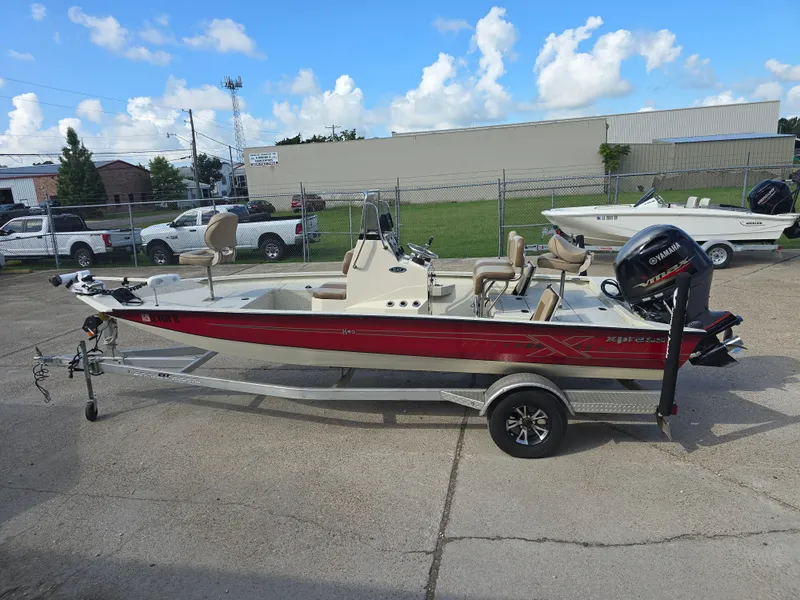 Slide: The Image of 2020 Xpress H20B boat with Yamaha motor on trailer, parked outdoors. - 11