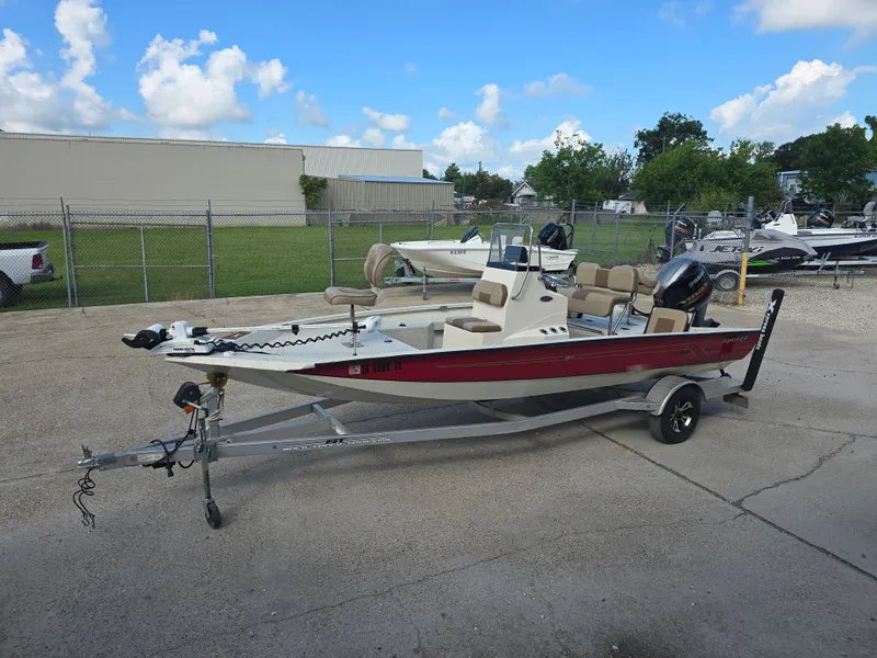 Slide: The Image of 2020 Xpress H20B boat on trailer, parked outdoors under a clear blue sky. - 12