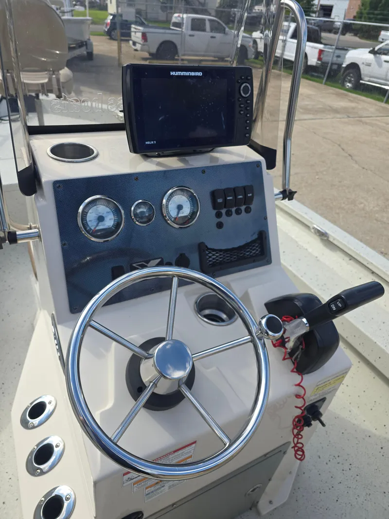 Slide: The Image of 2020 Xpress H20B boat console with steering wheel and navigation system. - 14