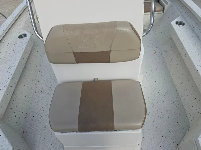 Slide: The Image of 2020 Xpress H20B boat seat with beige upholstery and speckled flooring. - 16