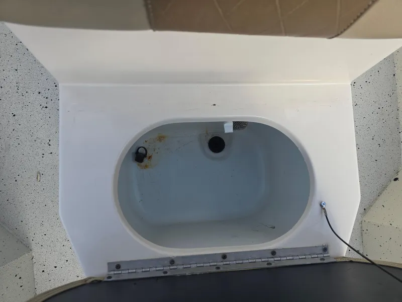 Slide: The Image of 2020 Xpress H20B boat livewell interior with drain and plug. - 17