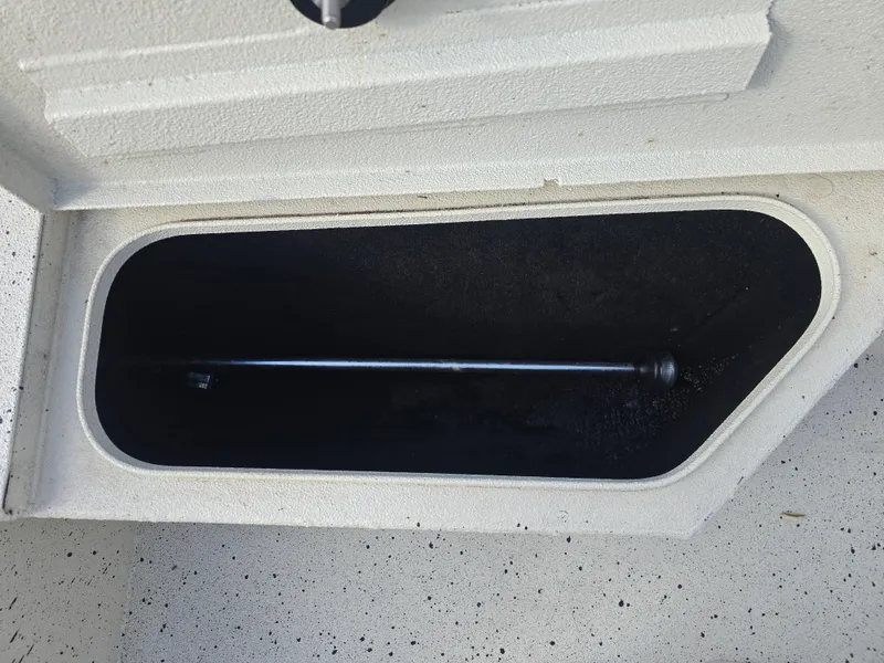 Slide: The Image of Open storage compartment in 2020 Xpress H20B boat. - 18