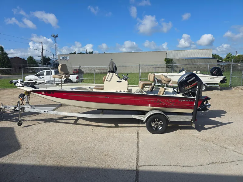 Slide: The Image of 2020 Xpress H20B boat with Yamaha motor on trailer, parked outdoors under blue sky. - 2
