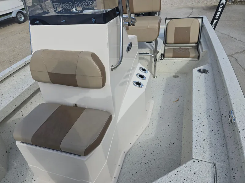 Slide: The Image of 2020 Xpress H20B boat interior with beige seating and console, showcasing modern design. - 21