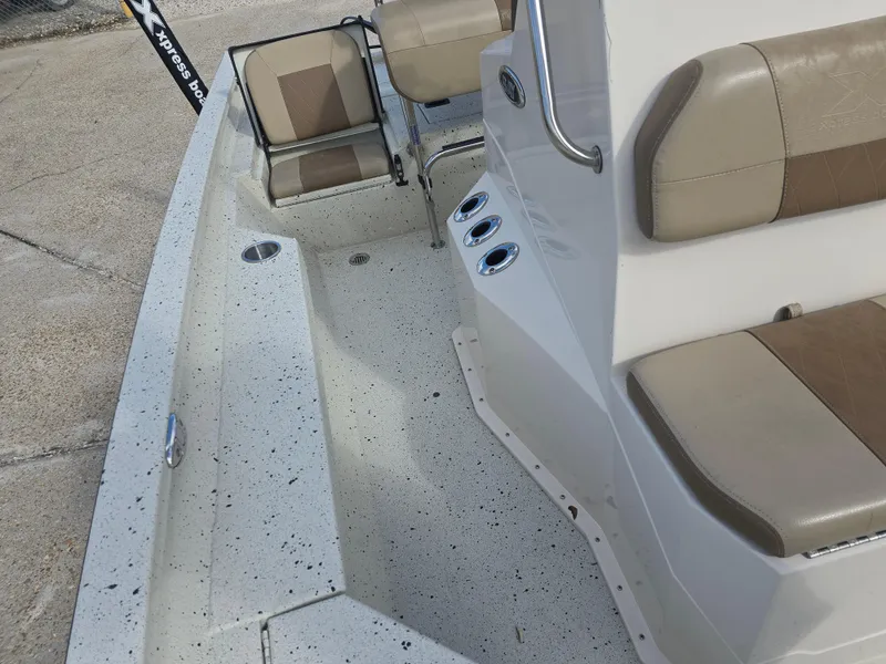 Slide: The Image of 2020 Xpress H20B boat interior with beige seating and speckled flooring. - 22
