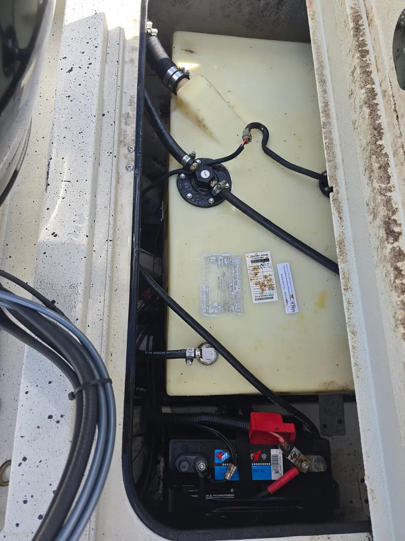 Slide: The Image of 2020 Xpress H20B boat fuel tank and battery compartment, showing wiring and connections. - 24