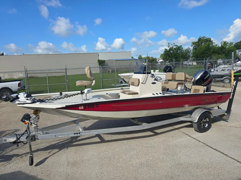 Slide: The Image of 2020 Xpress H20B boat on trailer, red and white, parked outdoors. - 3