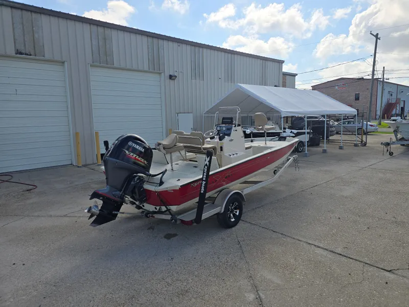 Slide: The Image of 2020 Xpress H20B boat with Yamaha motor parked outside a warehouse. - 8