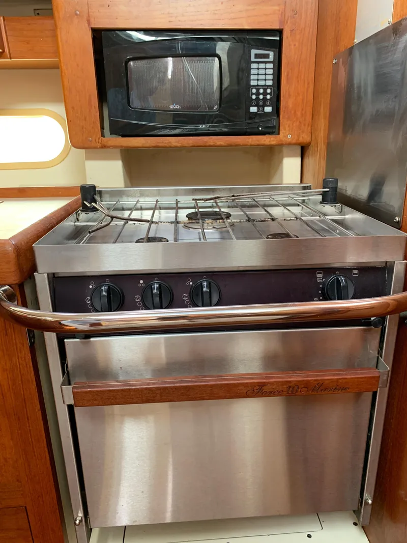 Slide: The Image of 2002 Hunter 410 yacht kitchen with stove and microwave. - 10