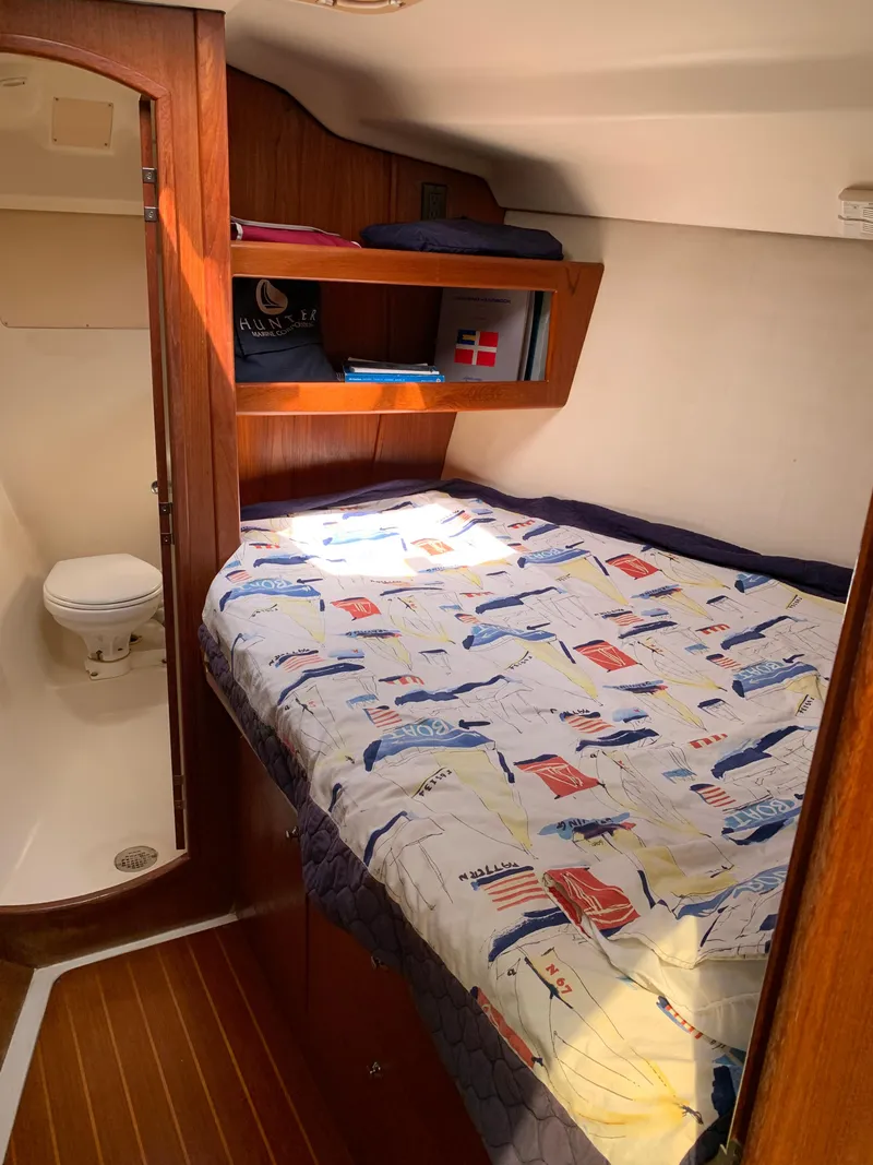 Slide: The Image of Cozy cabin interior of 2002 Hunter 410 sailboat with bed and compact bathroom. - 12