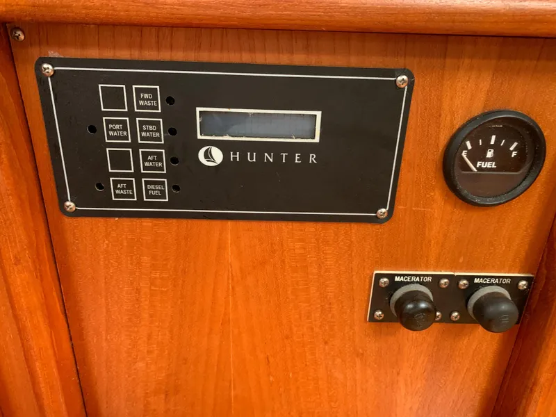 Slide: The Image of Control panel of a 2002 Hunter 410 boat with fuel gauge and macerator switches. - 13