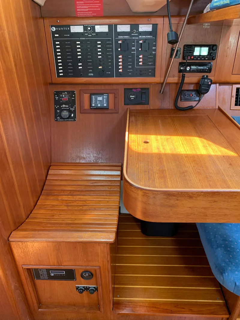Slide: The Image of Control panel and wooden interior of a 2002 Hunter 410 sailboat. - 15