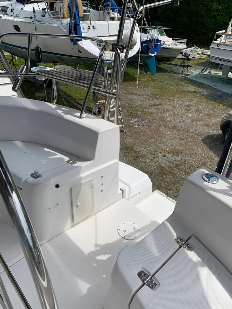 Slide: The Image of Hunter 410 sailboat deck, 2002 model, in a boatyard with other vessels. - 16
