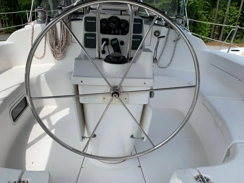 Slide: The Image of Cockpit of 2002 Hunter 410 sailboat with steering wheel and navigation instruments. - 25