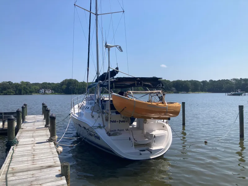 Slide: The Image of Sailboat docked with kayak on stern, Hunter 410 model, 2002, on calm water. - 27