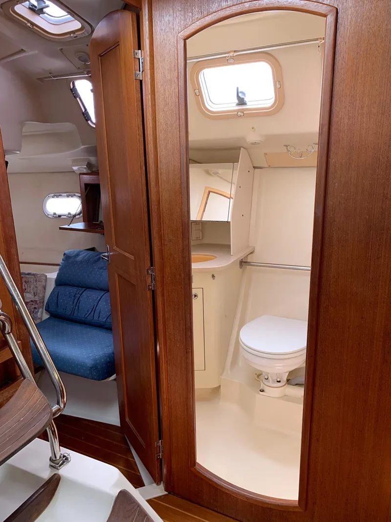 Slide: The Image of Interior of 2002 Hunter 410 sailboat showing bathroom and seating area. - 4