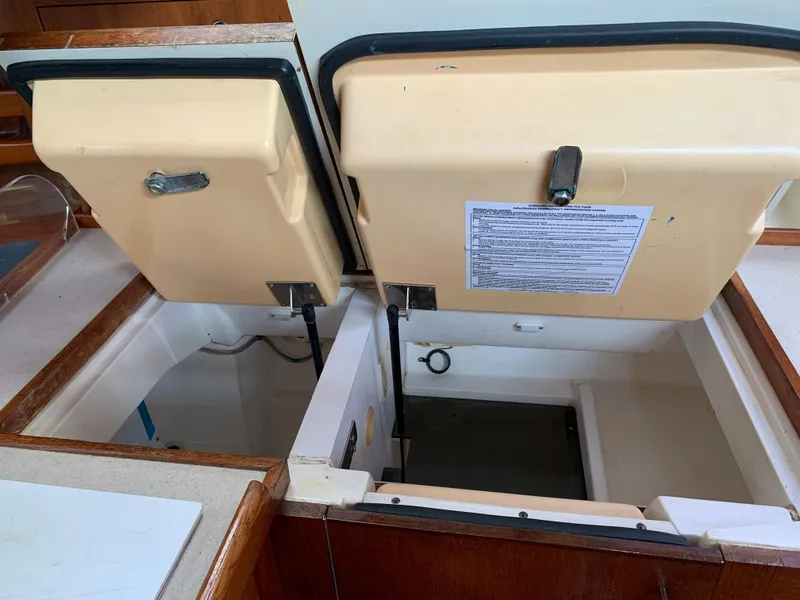 Slide: The Image of Open storage compartments on a 2002 Hunter 410 boat interior. - 5