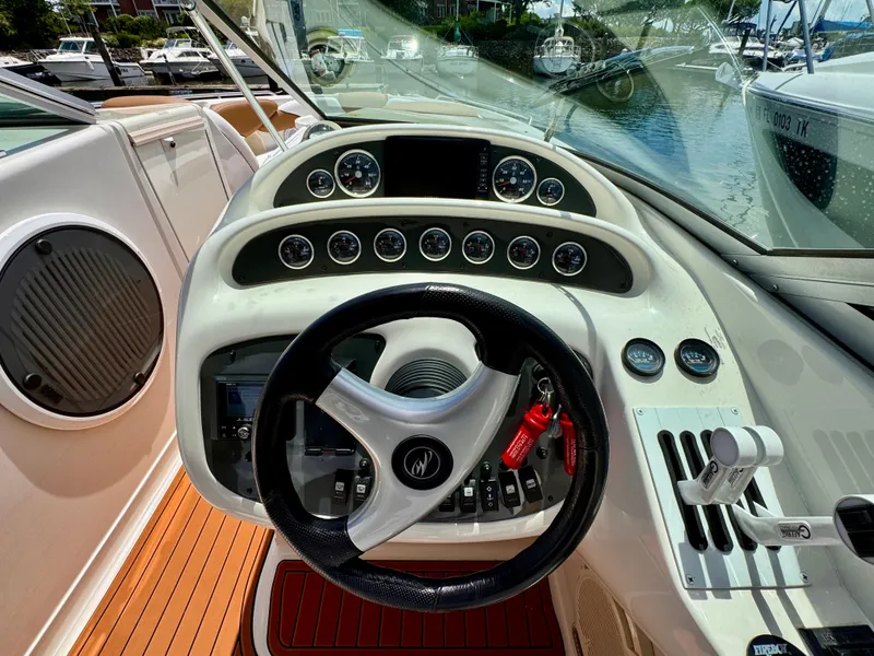 Slide: The Image of 2005 Monterey 298SS Super Sport boat dashboard with steering wheel and gauges. - 12