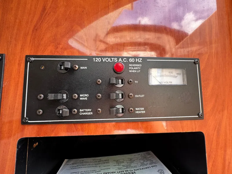Slide: The Image of Control panel of a 2005 Monterey 298SS Super Sport boat, showing switches and voltage meter. - 21