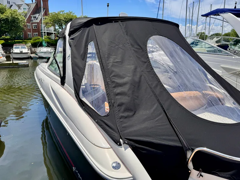 Slide: The Image of 2005 Monterey 298SS Super Sport boat with black canopy docked in marina. - 4