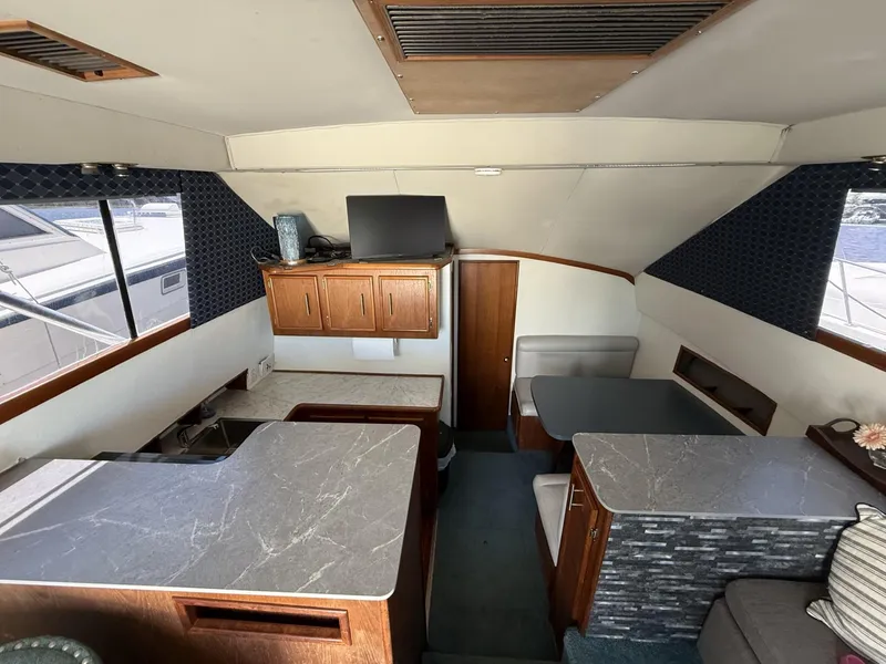 Slide: The Image of 1988 Ocean Yachts 35 Flybridge interior with modern kitchen and seating area. - 12
