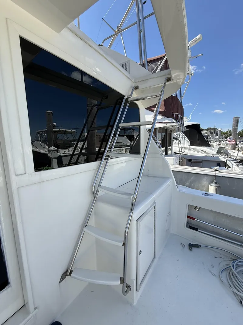 Slide: The Image of 1988 Ocean Yachts 35 Flybridge with ladder and marina view. - 5